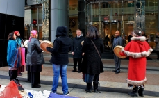 Native women drumming on the steps of TransCanada's head office