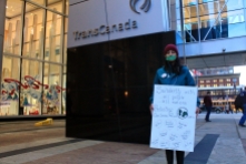 A protester stands outisde of TransCanada building.