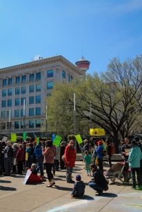 People in Calgary assembled with their signs